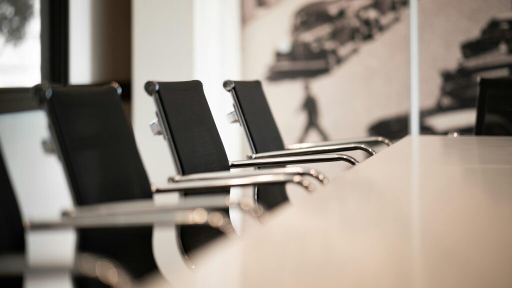 board room table with black office chairs